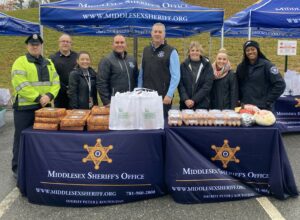 “I look at public safety through the lens of public health,” says Middlesex County Sheriff Peter J. Koutoujian, center, in blue shirt, distributing Thanksgiving meal kits for the loved ones of individuals incarcerated at the Middlesex Jail and House of Correction.