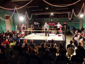 Sheldon Goldberg, in the center of the ring in coat and tie, sold out many venues in the Boston area with his popular New England Championship Wrestling live events.